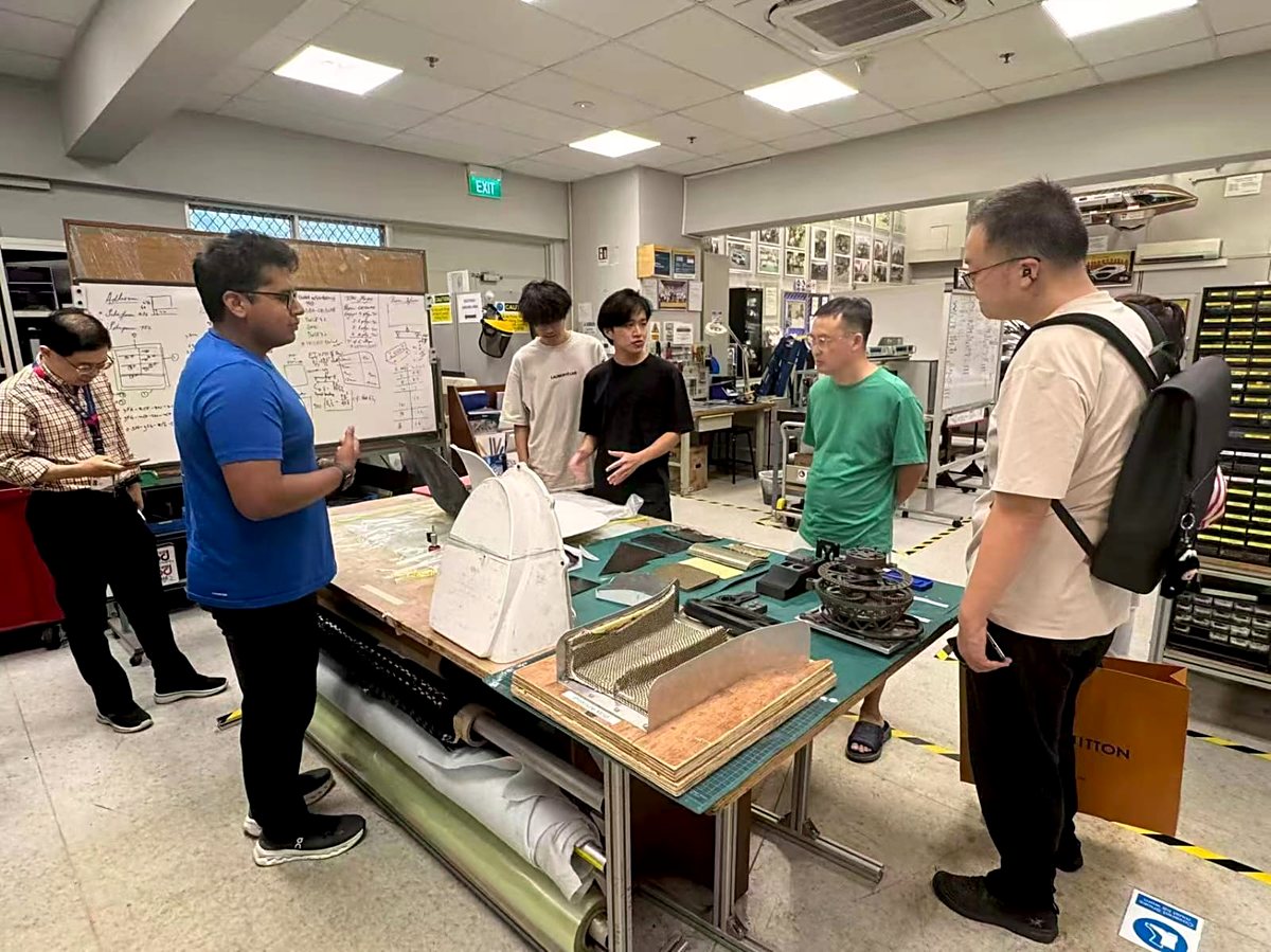 S Triformix engineers reviewing hardware prototypes and materials in a development workshop
