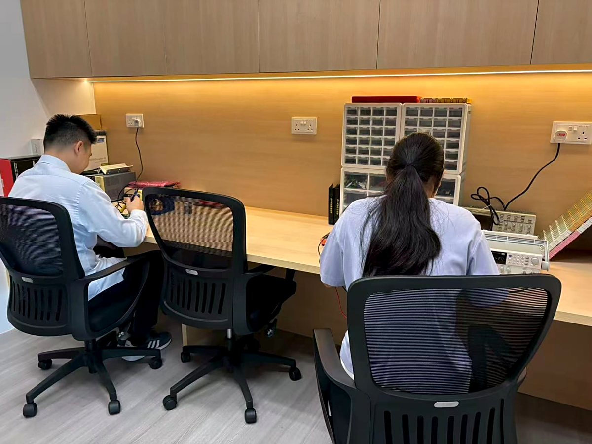 S Triformix engineers testing and validating power modules at an electronics lab bench